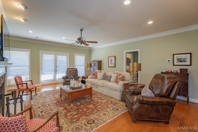 living room with ornamental molding, ceiling fan, and hardwood / wood-style floors