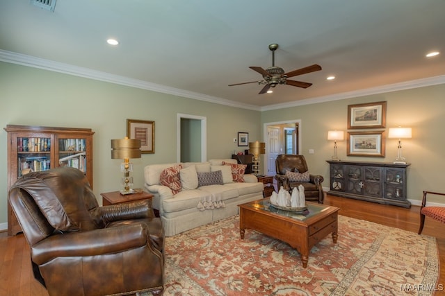 living room with ceiling fan, hardwood / wood-style flooring, and crown molding