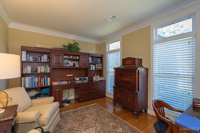 home office with ornamental molding and hardwood / wood-style flooring