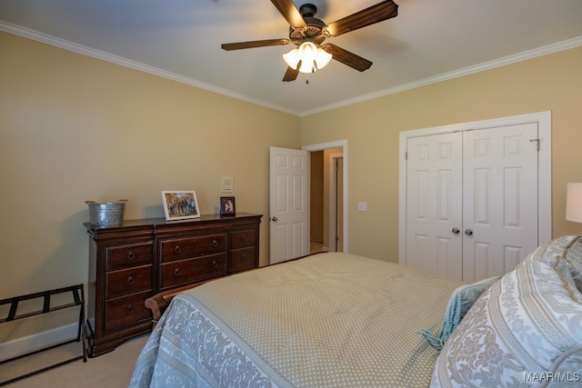 carpeted bedroom featuring a closet, ornamental molding, and ceiling fan