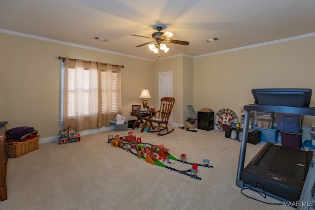 recreation room with ornamental molding, ceiling fan, and carpet flooring