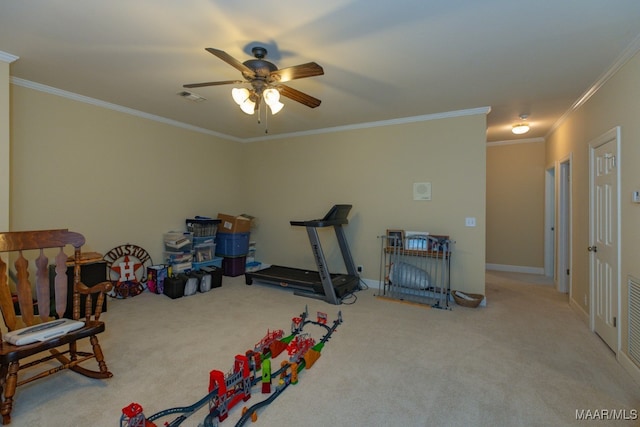 workout room featuring ornamental molding, carpet flooring, and ceiling fan