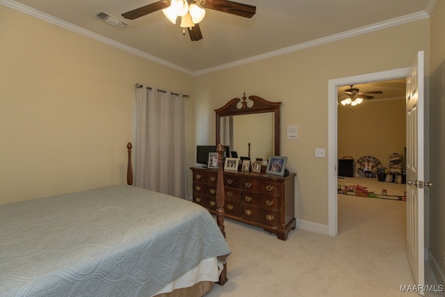 carpeted bedroom with ornamental molding and ceiling fan