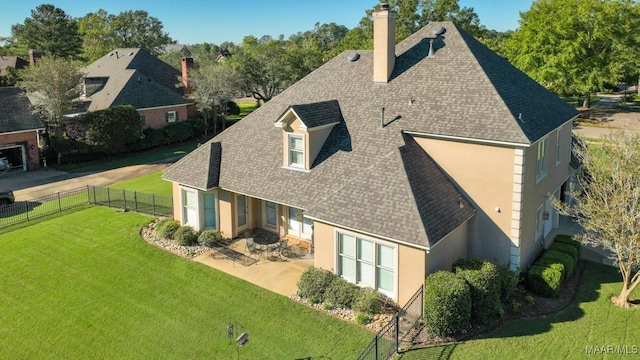 8301 Wynlakes Blvd, Montgomery, AL 36117 - rear view of property with a yard, stucco siding, roof with shingles, fence, and a chimney
