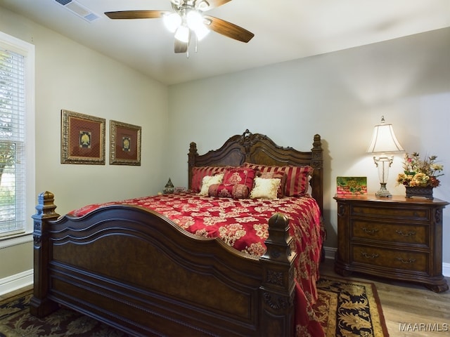 bedroom with hardwood / wood-style floors and ceiling fan