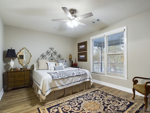 bedroom featuring hardwood / wood-style floors and ceiling fan