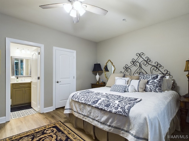 bedroom with hardwood / wood-style flooring, sink, connected bathroom, and ceiling fan