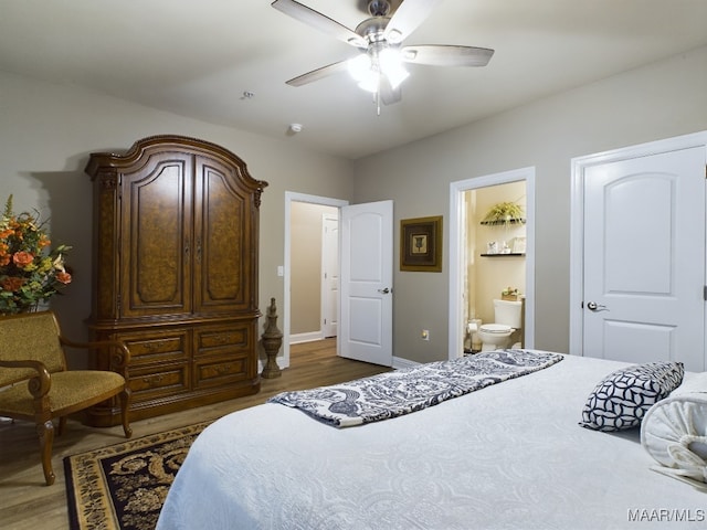 bedroom featuring ensuite bath, hardwood / wood-style flooring, and ceiling fan