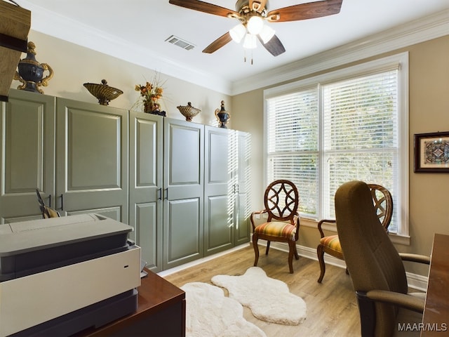 living area featuring light hardwood / wood-style floors, ornamental molding, and ceiling fan