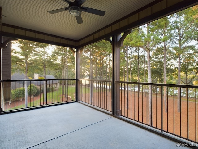 unfurnished sunroom featuring ceiling fan