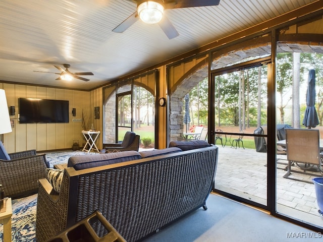 sunroom featuring a wealth of natural light and ceiling fan