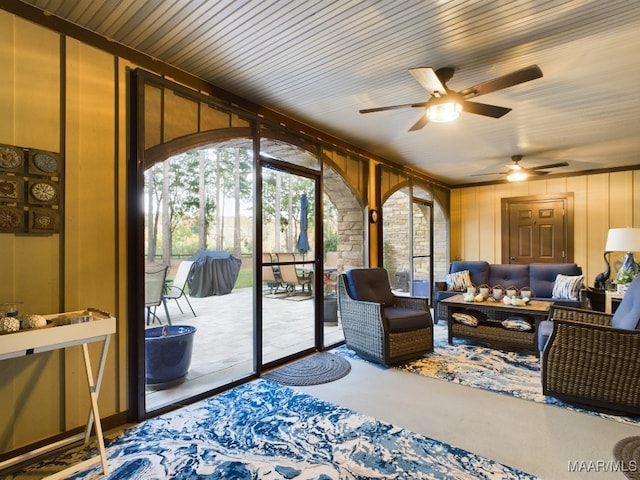 sunroom featuring ceiling fan and wooden ceiling