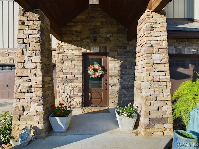 doorway to property with a garage