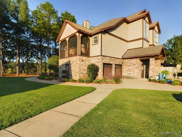 view of front of house featuring a front yard and a sunroom