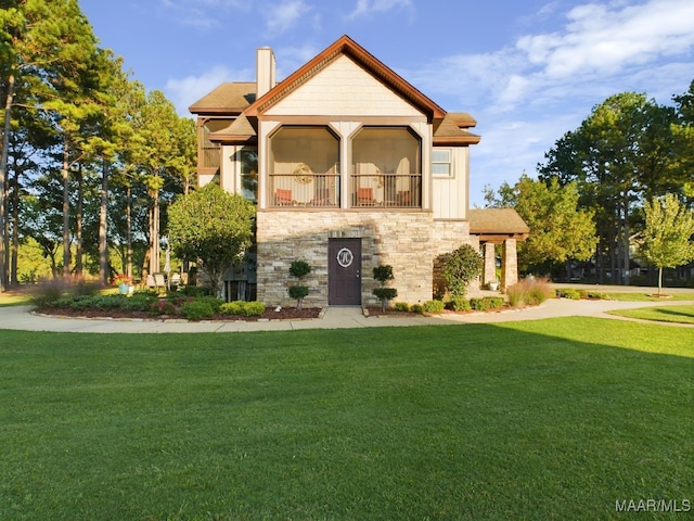 view of front of home with a balcony and a front yard