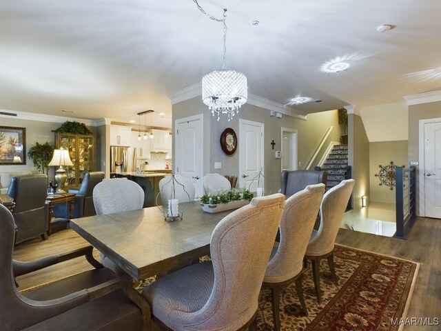 dining space with crown molding, a chandelier, and dark wood-type flooring