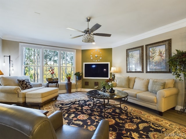 living room with crown molding, wood-type flooring, and ceiling fan