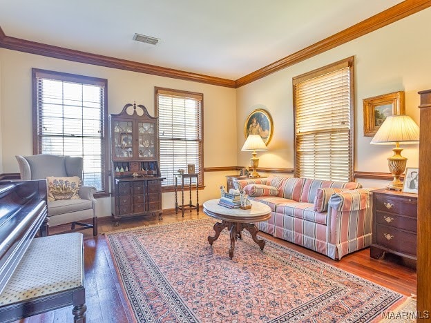 living room with crown molding and hardwood / wood-style floors