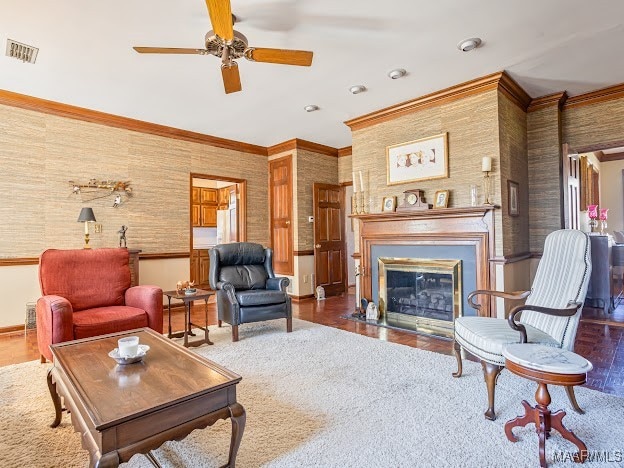 living room with ceiling fan, dark wood-type flooring, and ornamental molding