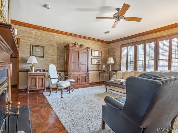 living room featuring crown molding, ceiling fan, and dark parquet flooring