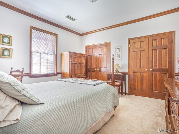 bedroom with carpet flooring and ornamental molding