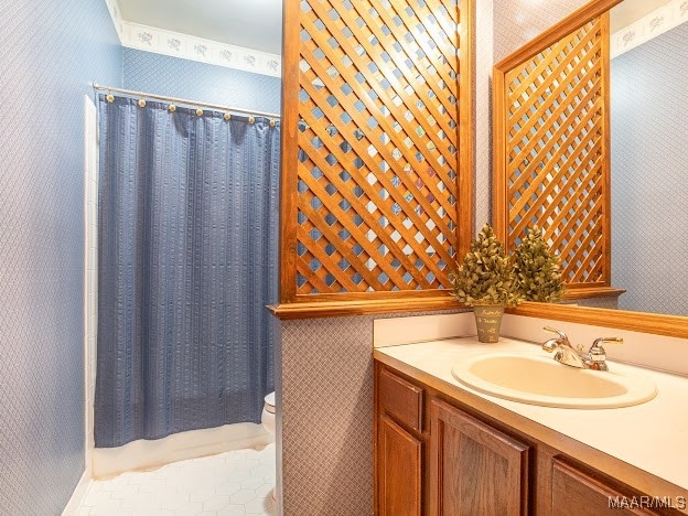 bathroom with toilet, vanity, and a shower with shower curtain