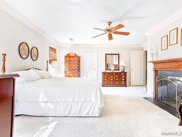 carpeted bedroom featuring ceiling fan and crown molding