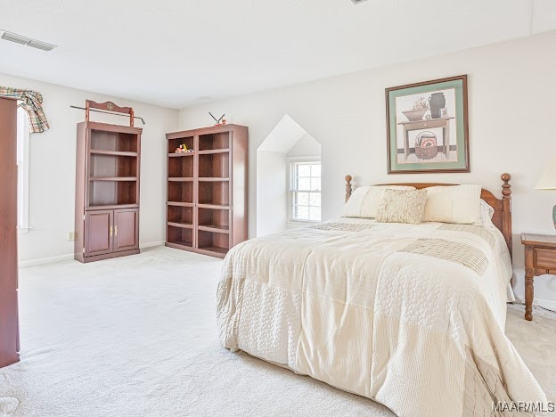 bedroom featuring light carpet