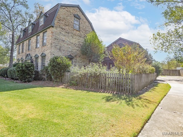 view of property exterior with a lawn