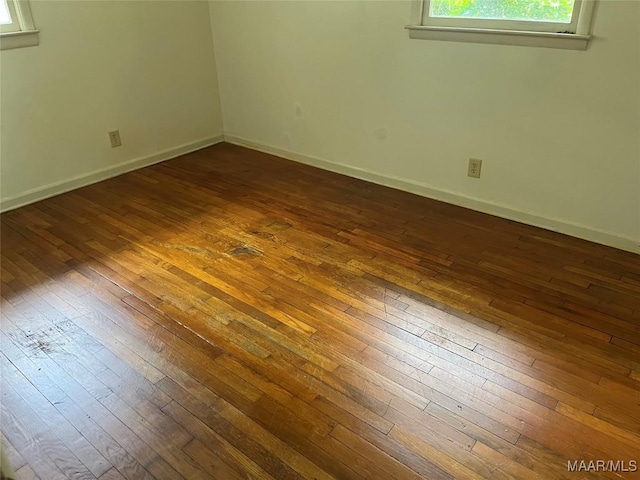 unfurnished room with dark hardwood / wood-style floors