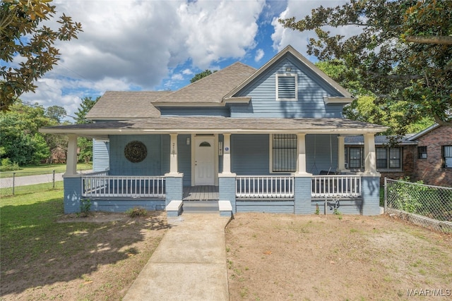 view of front facade with a front yard and covered porch