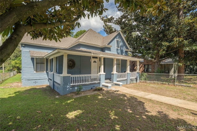 farmhouse inspired home featuring a front yard and covered porch