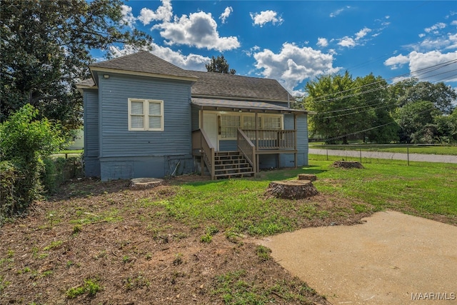 back of property with a lawn