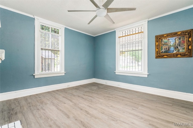 empty room featuring ornamental molding, hardwood / wood-style flooring, and ceiling fan