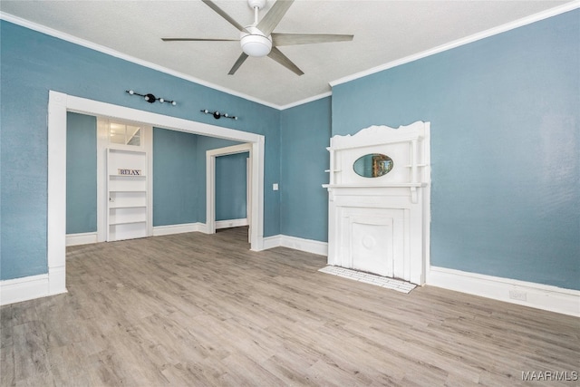 unfurnished living room featuring ceiling fan, ornamental molding, a textured ceiling, and hardwood / wood-style floors