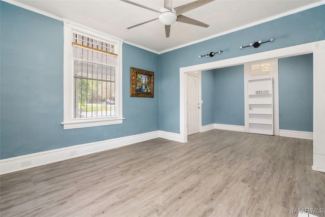 unfurnished room with ornamental molding, hardwood / wood-style flooring, a textured ceiling, and ceiling fan