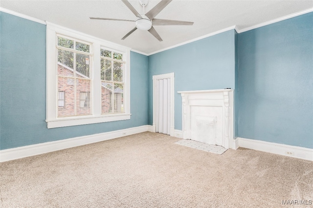 spare room featuring crown molding, ceiling fan, and carpet