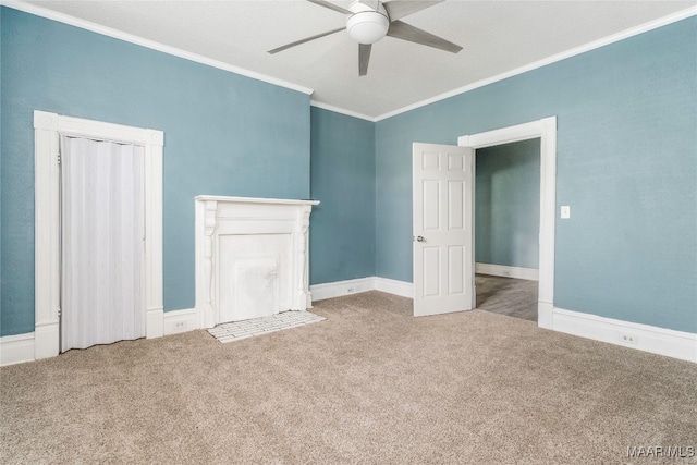 carpeted empty room featuring crown molding, a textured ceiling, and ceiling fan