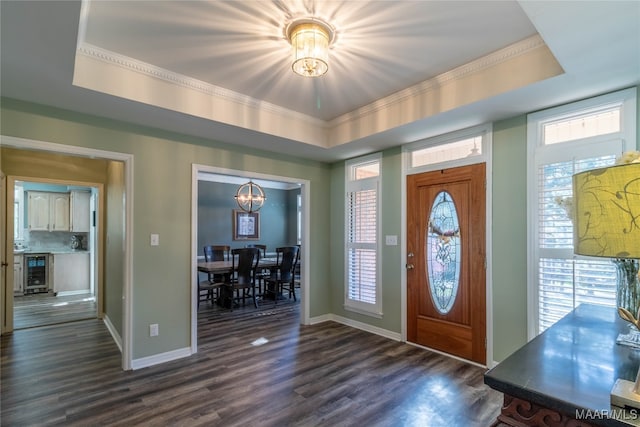 foyer featuring wine cooler, dark wood-style flooring, and a raised ceiling