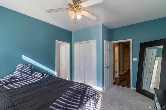 unfurnished bedroom with a ceiling fan, carpet, a closet, and baseboards