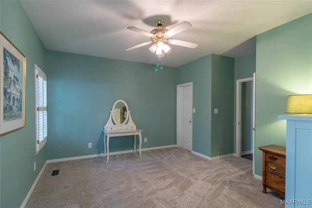 unfurnished bedroom with baseboards, visible vents, ceiling fan, and carpet flooring