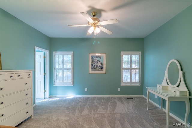 unfurnished bedroom featuring carpet, multiple windows, and baseboards