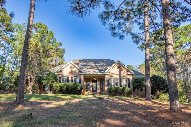 view of front of property with a front lawn and brick siding