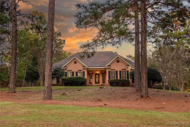 view of front of property with a front yard and brick siding