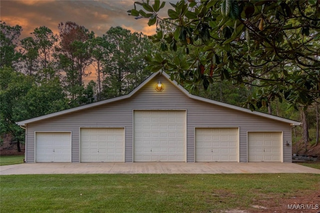 garage at dusk with a yard