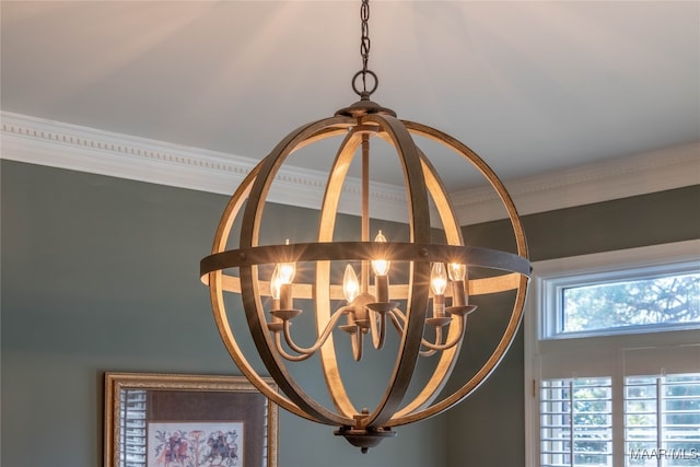 room details featuring ornamental molding and an inviting chandelier