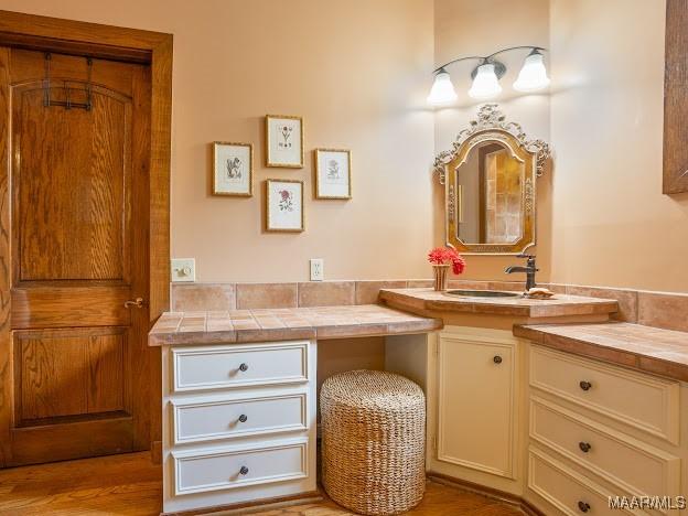 bathroom featuring wood finished floors and vanity