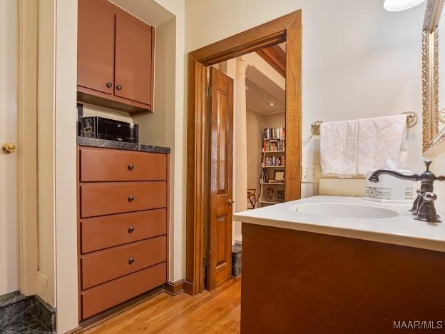 bathroom with vanity and wood finished floors