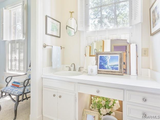 bathroom featuring a wealth of natural light and vanity