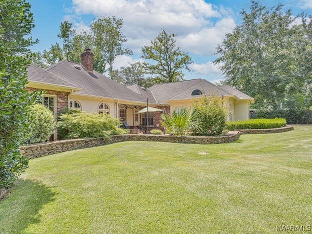 ranch-style home featuring a front yard